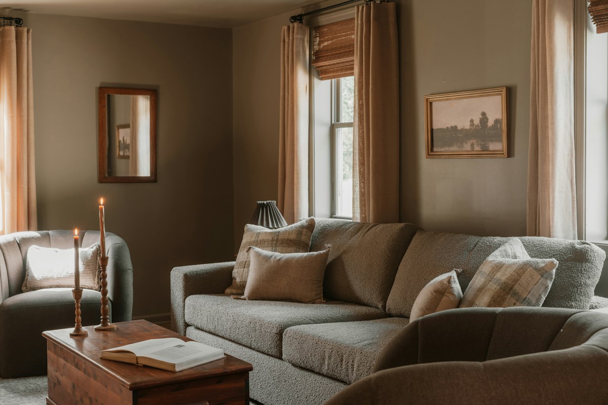 Warm living room with a sofa, armchairs, and a wooden coffee table