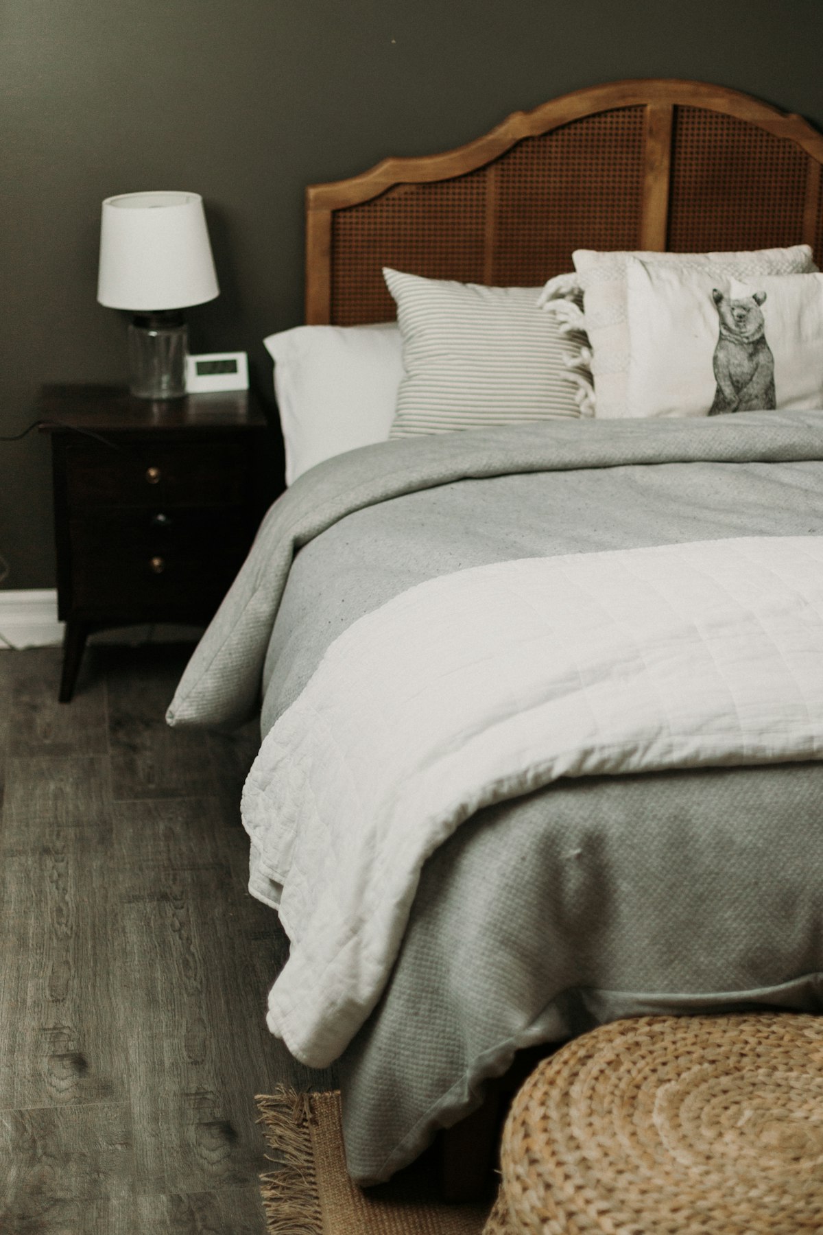 Cozy bedroom with a rattan headboard and layered bedding