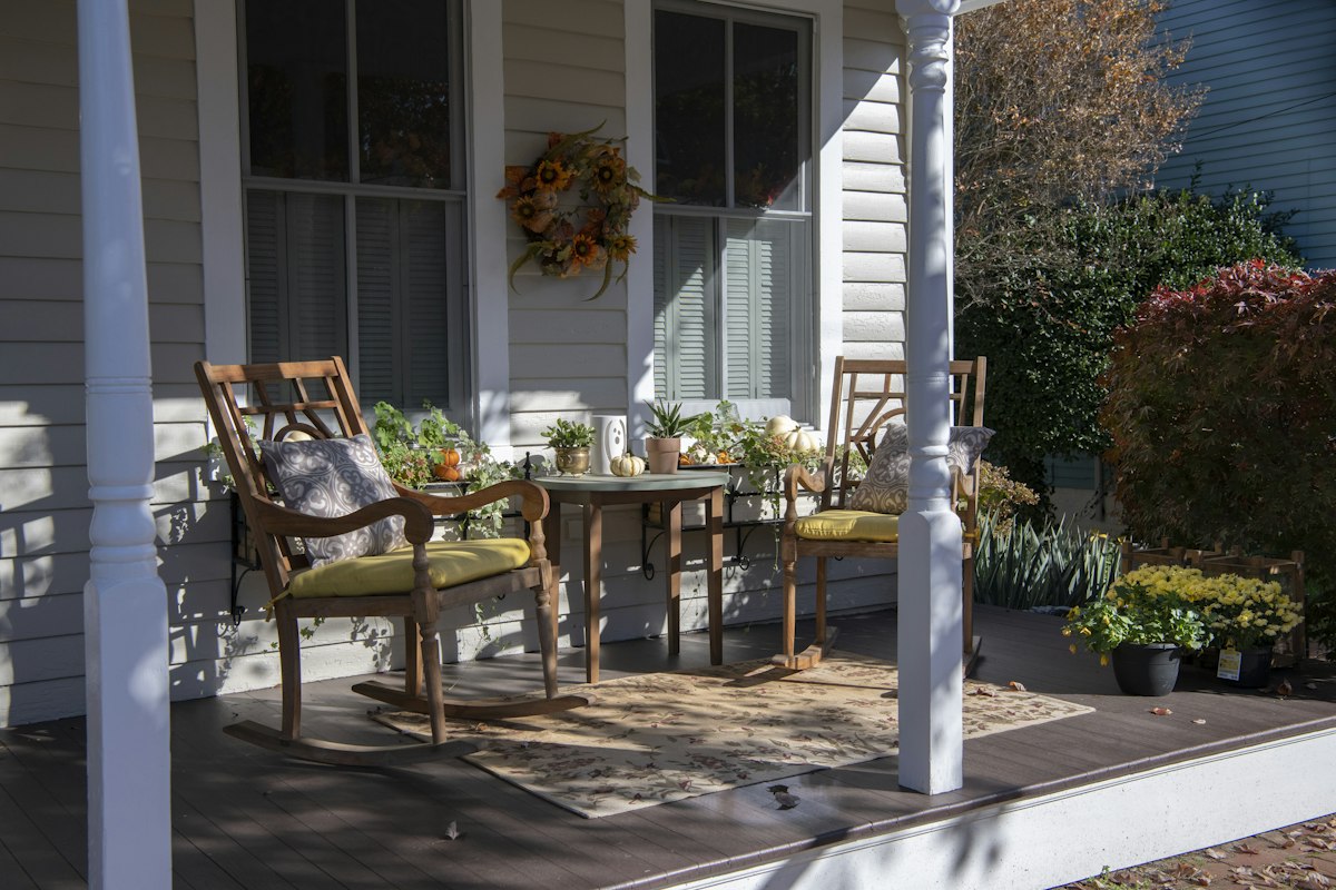 Front porch with wooden rocking chairs and potted plants